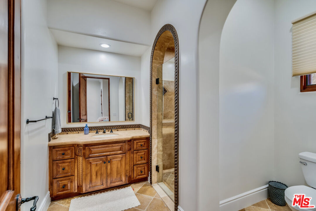 18000 Sunset Point Road Poway, CA 92064 - Photo 26 of 43 a en suite bathroom with a granite countertop sink and a mirror