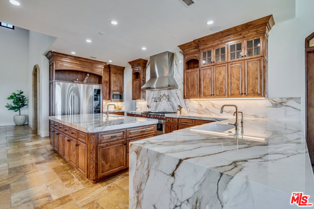 18000 Sunset Point Road Poway, CA 92064 - Photo 8 of 43 a kitchen with stainless steel appliances granite countertop a sink and a refrigerator