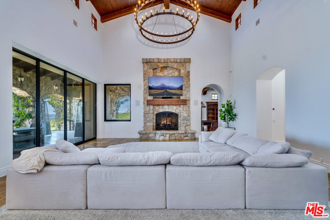 18000 Sunset Point Road Poway, CA 92064 - Photo 10 of 43 a living room with furniture a fireplace and a large window