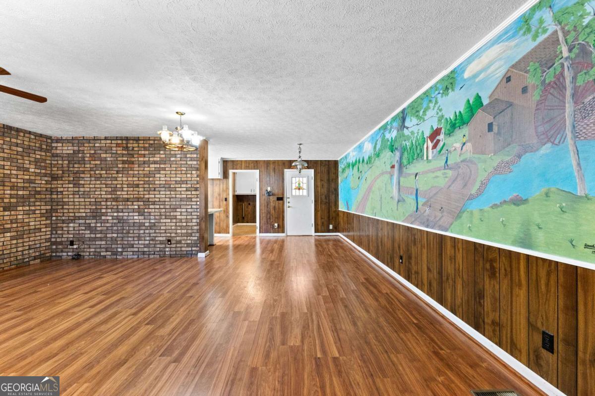 2540 Hannahs Mill Road Thomaston, GA 30286 - Photo 11 of 76 a view of an empty room with wooden floor and a window