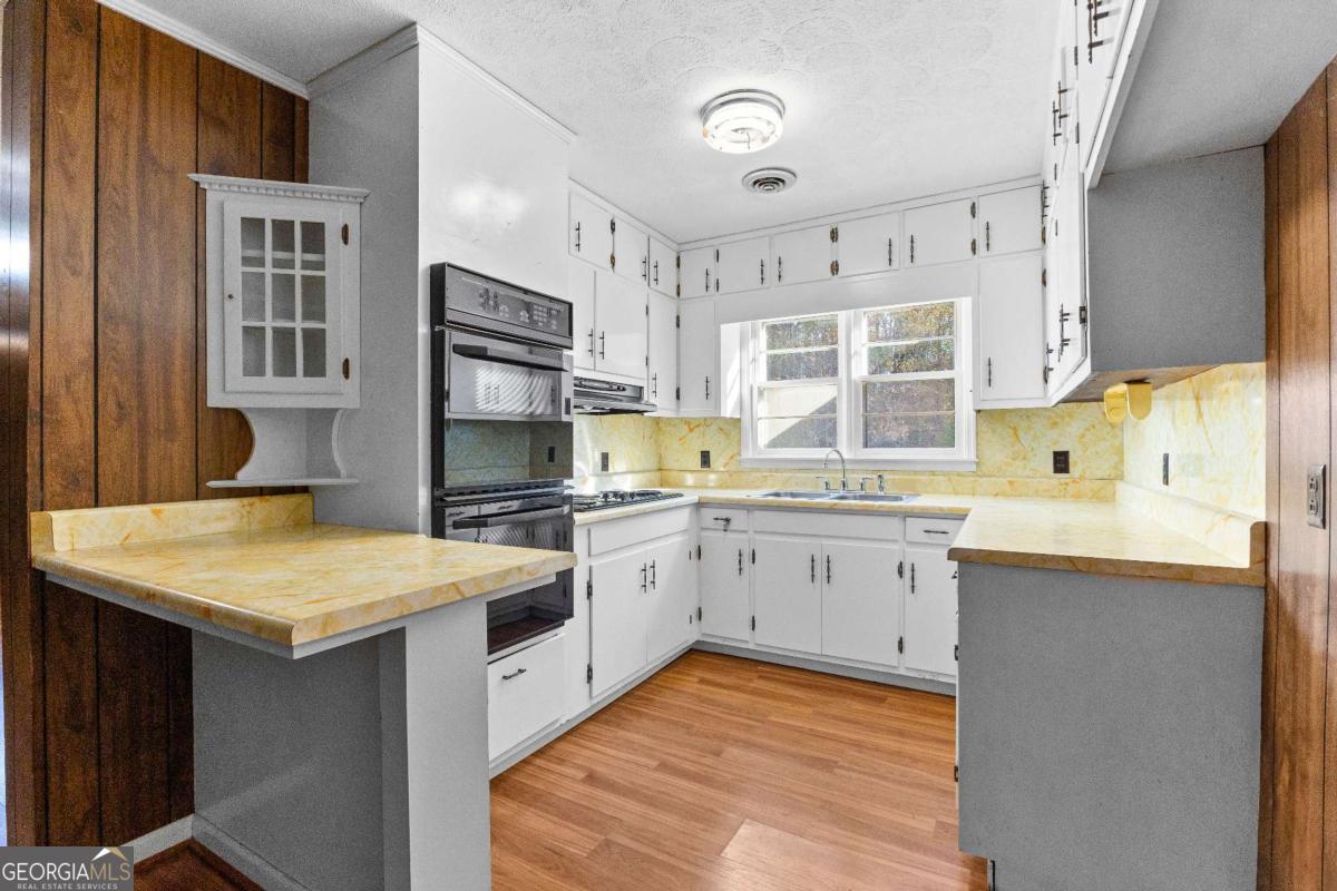 2540 Hannahs Mill Road Thomaston, GA 30286 - Photo 13 of 76 a kitchen with a sink stove and cabinets
