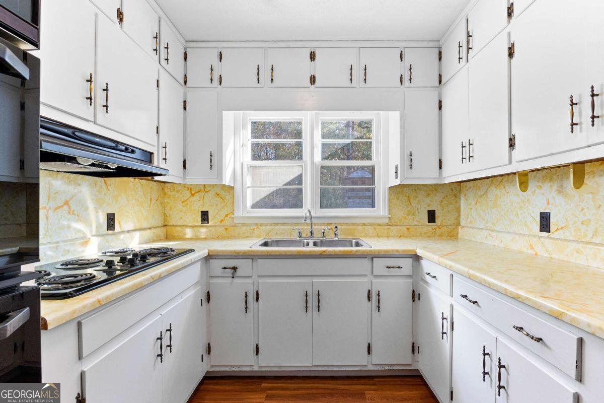 2540 Hannahs Mill Road Thomaston, GA 30286 - Photo 14 of 76 a kitchen with cabinets appliances a sink and a window