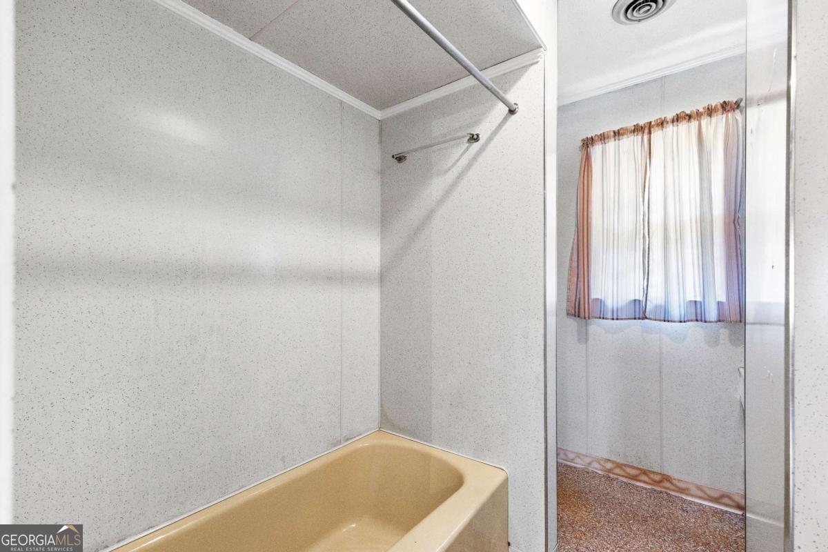 2540 Hannahs Mill Road Thomaston, GA 30286 - Photo 21 of 76 a bathroom with a tub and shower