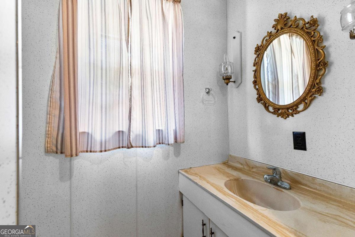 2540 Hannahs Mill Road Thomaston, GA 30286 - Photo 22 of 76 a bathroom with a sink and a mirror