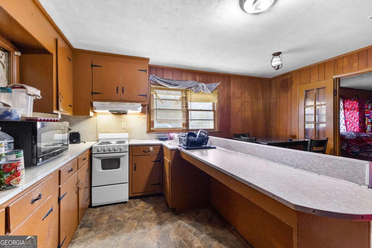 2540 Hannahs Mill Road Thomaston, GA 30286 - Photo 68 of 76 a kitchen with kitchen island granite countertop a sink stove and cabinets