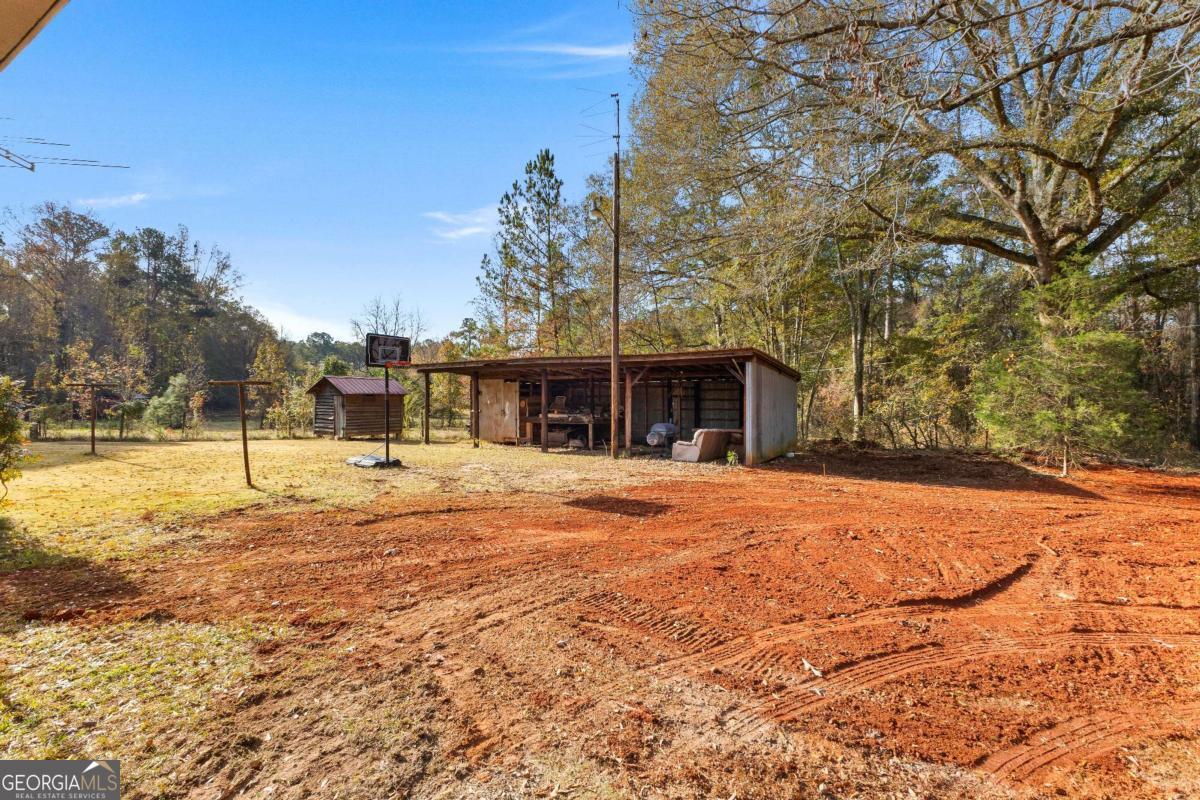 2540 Hannahs Mill Road Thomaston, GA 30286 - Photo 70 of 76 a swimming pool with trees in front of it
