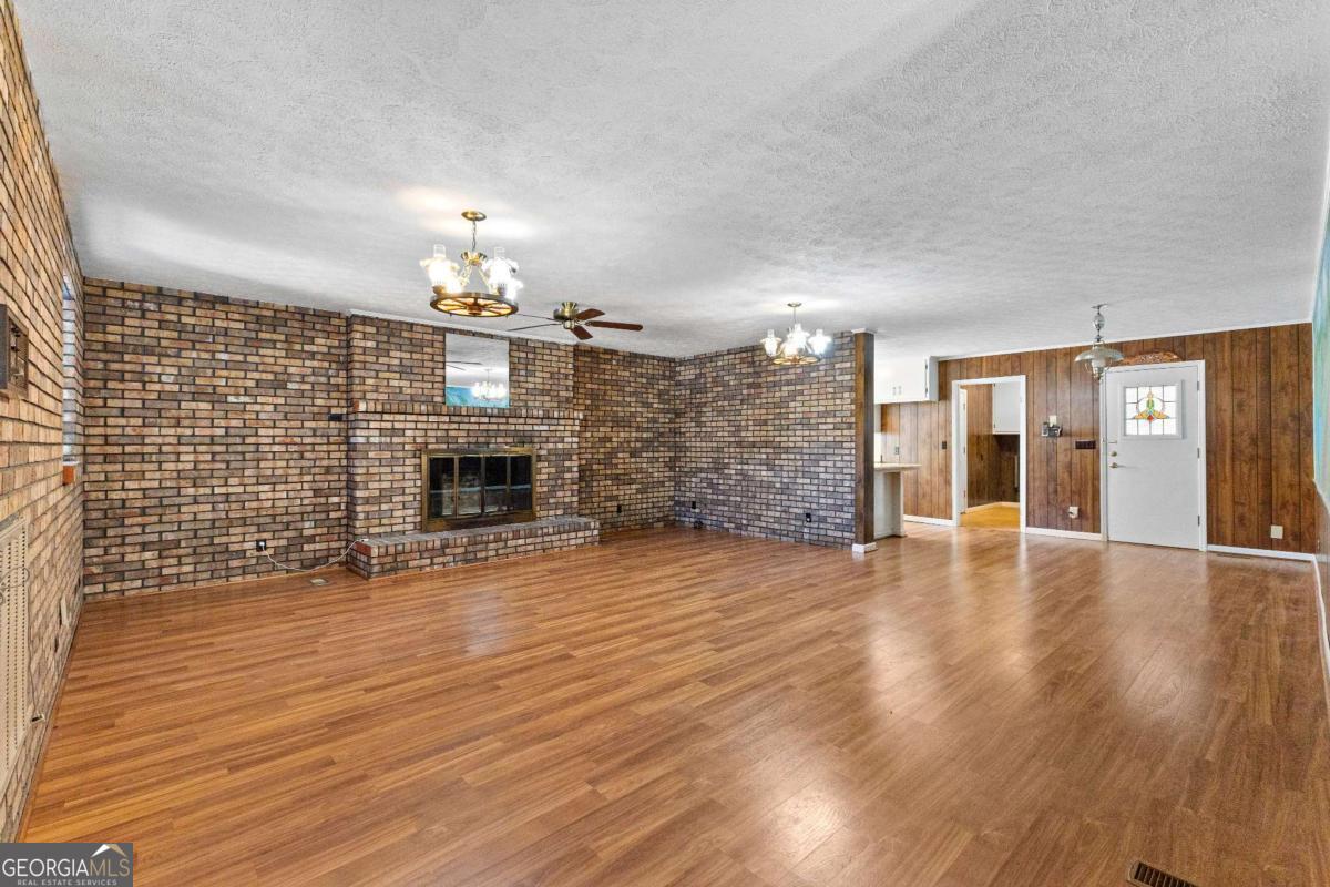 2540 Hannahs Mill Road Thomaston, GA 30286 - Photo 9 of 76 a view of a livingroom with wooden floor a fireplace and window