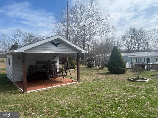 a view of a house with a yard and sitting area