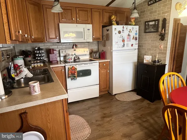 a kitchen with refrigerator and cabinets