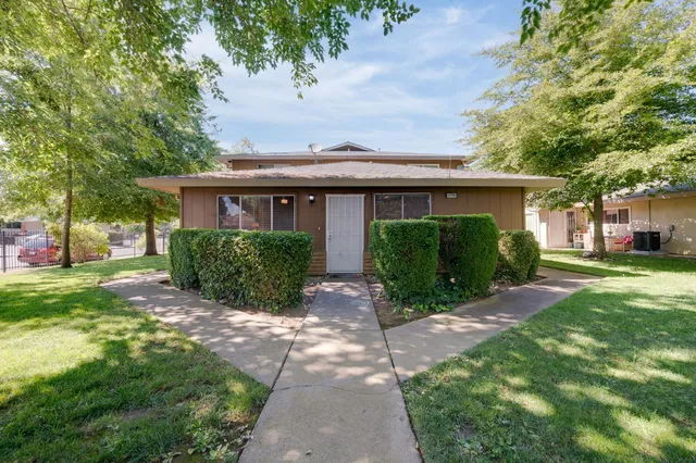 a front view of house with yard and green space