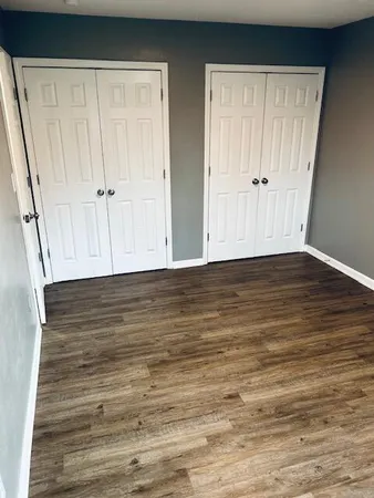 a view of room with wooden floor