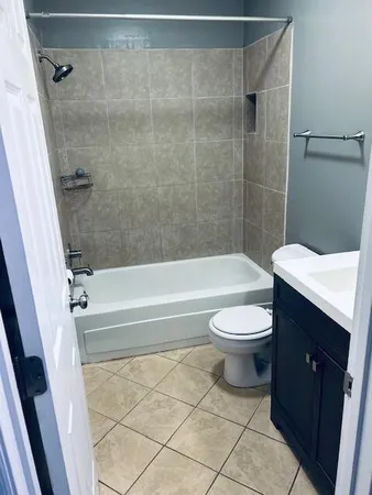 a bathroom with a toilet a sink and bathtub