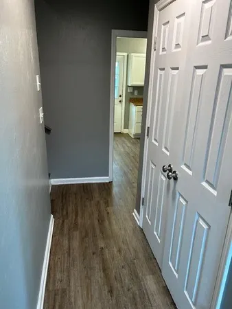 a view of a room with wooden floor