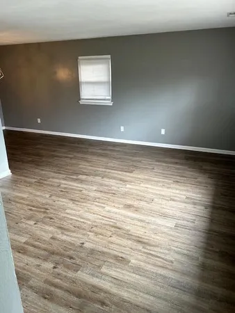 a view of a room with wooden floor