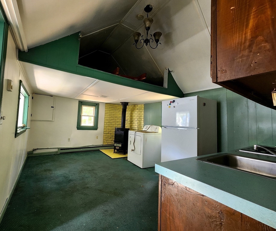 117 High Street Freetown, MA 02702 - Photo 9 of 18 a kitchen with a refrigerator and a stove