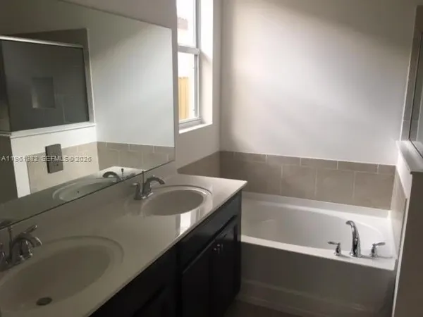 a bathroom with a bathtub and shower
