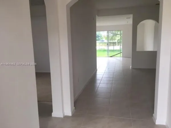a view of a room with wooden floor and windows