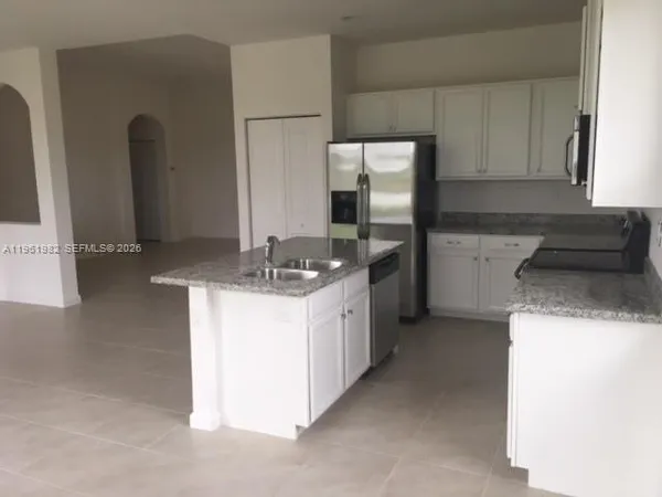 a kitchen with a sink and a refrigerator