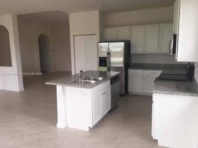 11842 Southwest 253rd Terrace Homestead, FL 33032 - Photo 4 of 15 a kitchen with a sink and a refrigerator