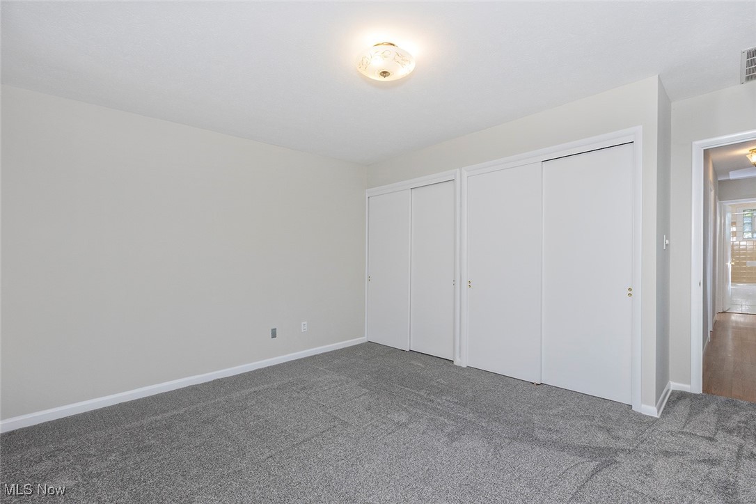 1691 Harwich Road Lyndhurst, OH 44124 - Photo 19 of 45 Bedroom with multiple closets and carpet.