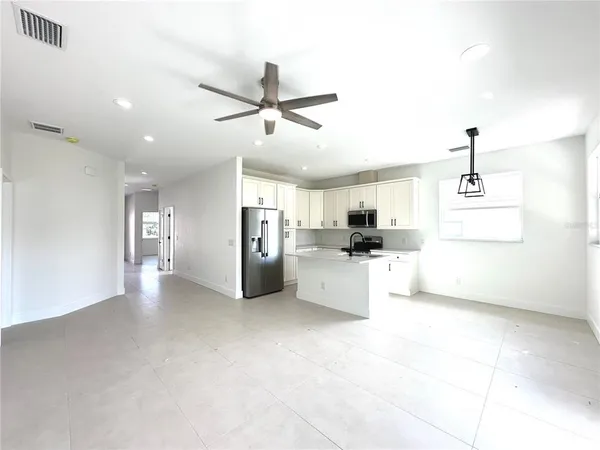 a view of a kitchen with a sink and microwave
