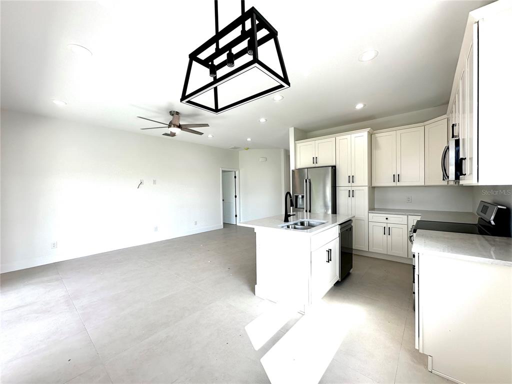 26129 Northern Cross Road Punta Gorda, FL 33983 - Photo 13 of 40 a large kitchen with cabinets a sink and appliances