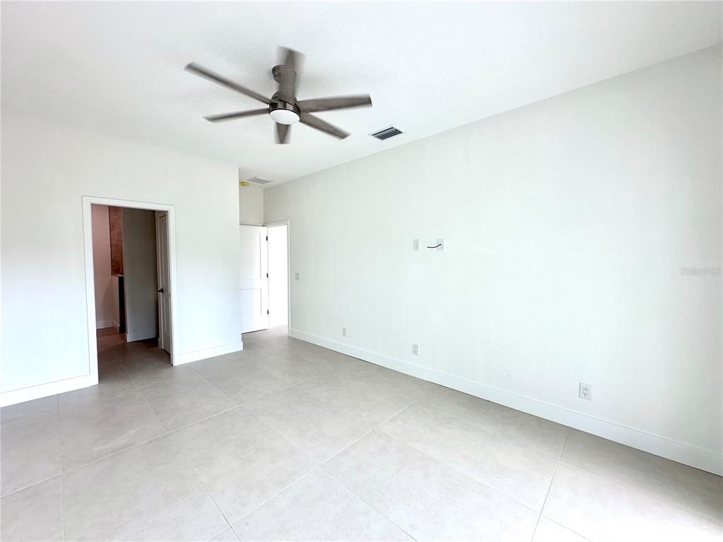 26129 Northern Cross Road Punta Gorda, FL 33983 - Photo 15 of 40 an empty room with a ceiling fan and a window