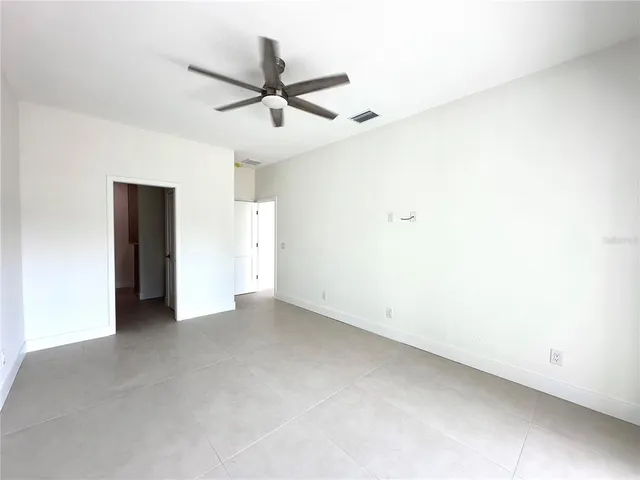 a view of a big room with a ceiling fan and a ceiling fan