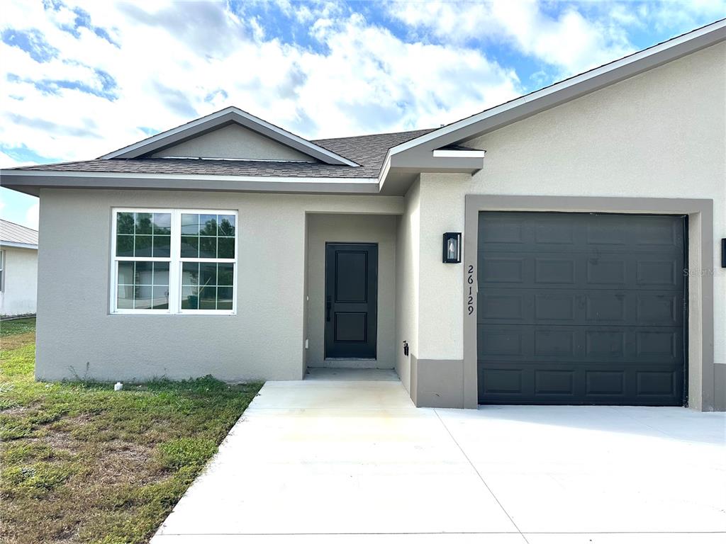 26129 Northern Cross Road Punta Gorda, FL 33983 - Photo 2 of 40 a front view of a house with a yard