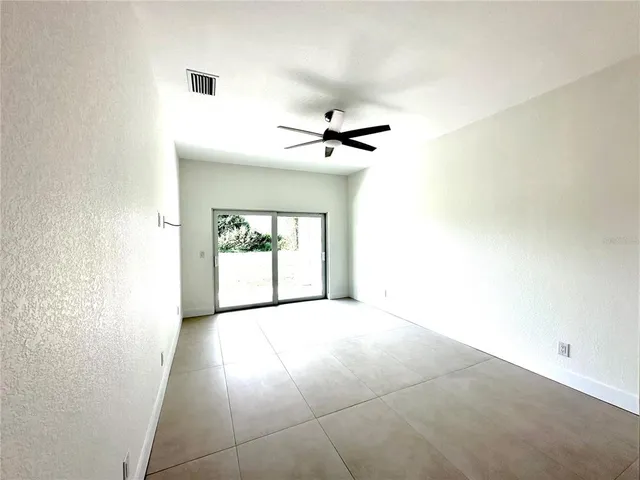 a view of a livingroom with a ceiling fan and window