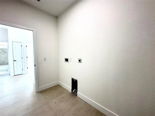 a kitchen with stainless steel appliances a sink a microwave a refrigerator and grey cabinets