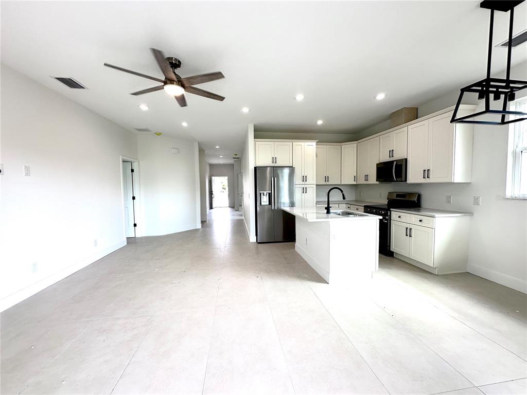 26129 Northern Cross Road Punta Gorda, FL 33983 - Photo 6 of 40 a view of kitchen with stainless steel appliances refrigerator oven microwave and cabinets