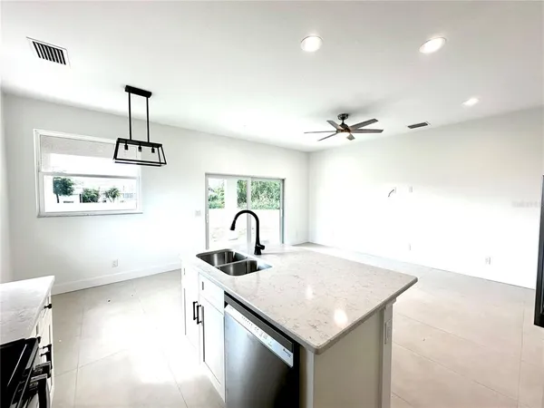 a kitchen with a sink cabinets and appliances