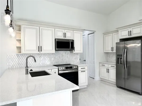 a kitchen with a refrigerator stove and sink
