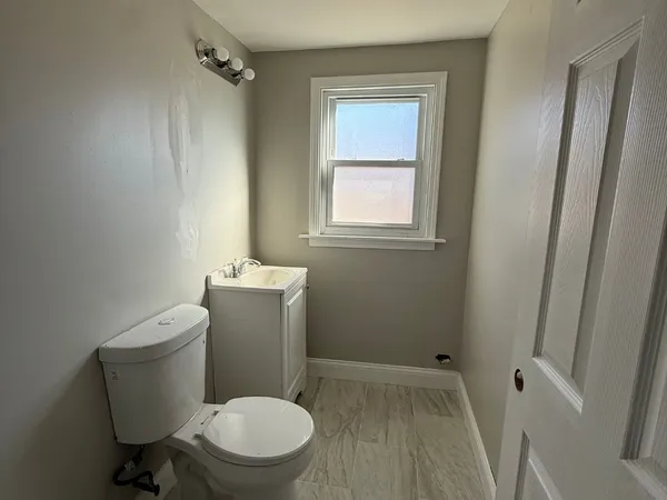 a white toilet sitting next to a bathroom sink