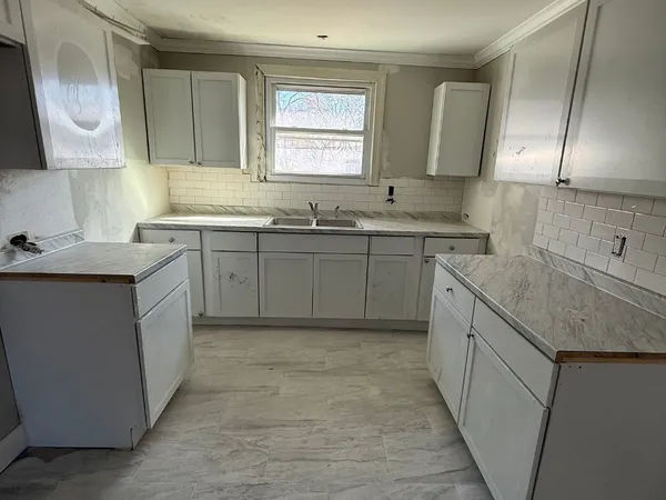 a kitchen with a sink stove and cabinets