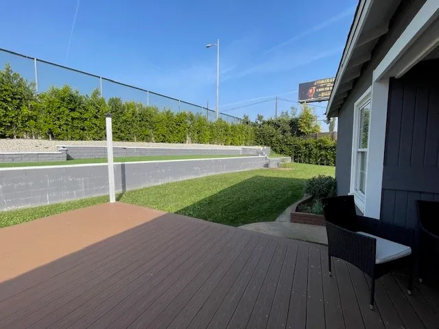 a view of a backyard with wooden fence