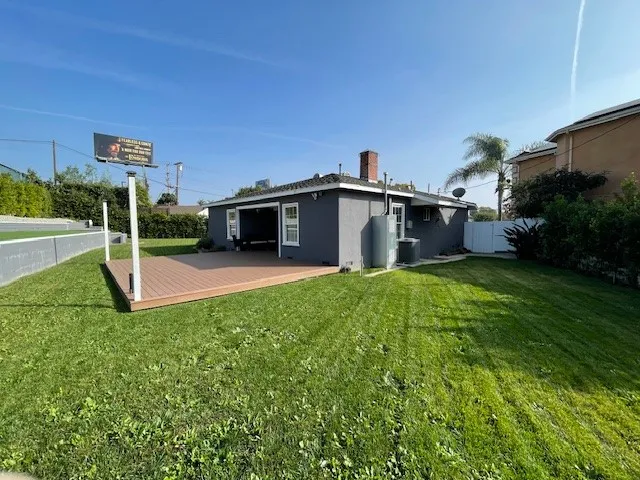 a view of a house with a backyard and a garden