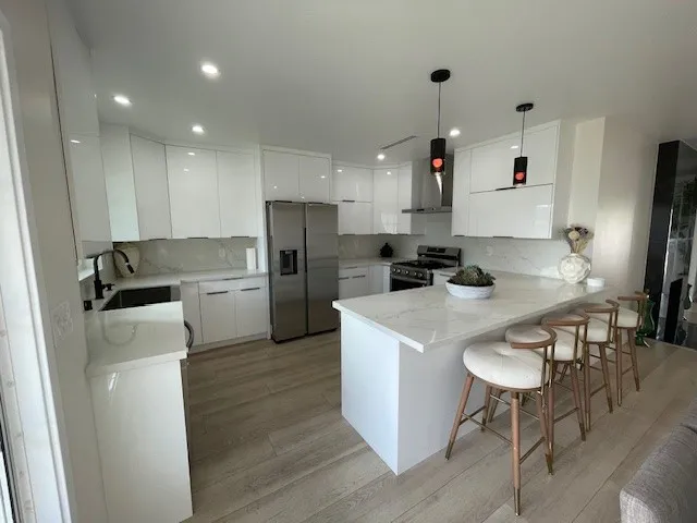 a kitchen with refrigerator cabinets and wooden floor
