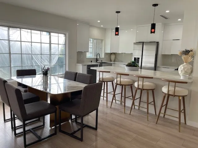 a dining room with furniture a window and wooden floor