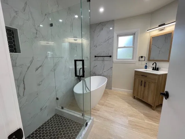 a bathroom with a sink a toilet a mirror and shower