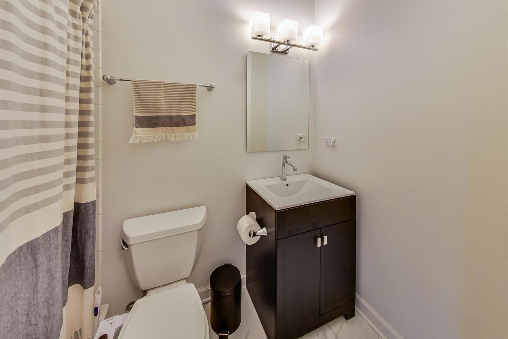 2128 West Walton Street, Unit 3W Chicago, IL 60622 - Photo 11 of 25 a bathroom with a toilet sink and mirror