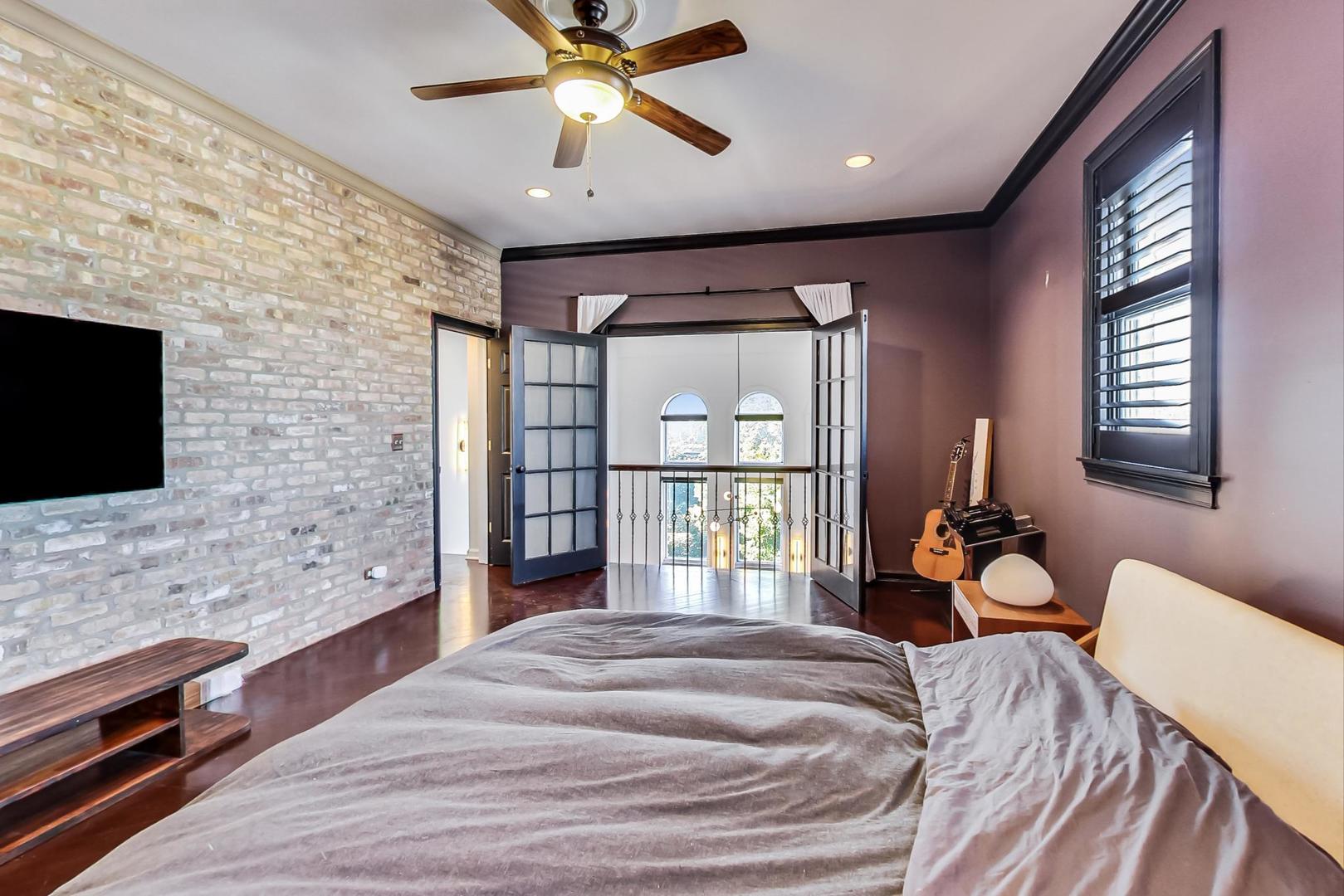 2128 West Walton Street, Unit 3W Chicago, IL 60622 - Photo 14 of 25 a spacious bedroom with a bed and a flat screen tv