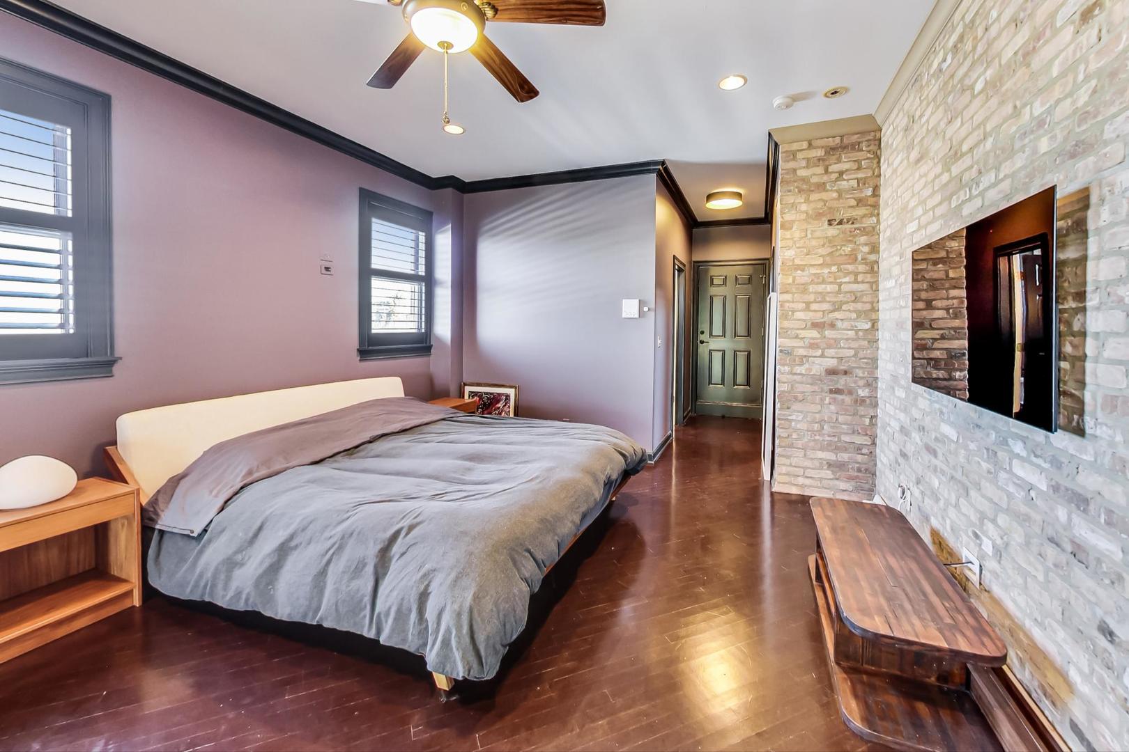 2128 West Walton Street, Unit 3W Chicago, IL 60622 - Photo 15 of 25 a bedroom with a bed and a chandelier