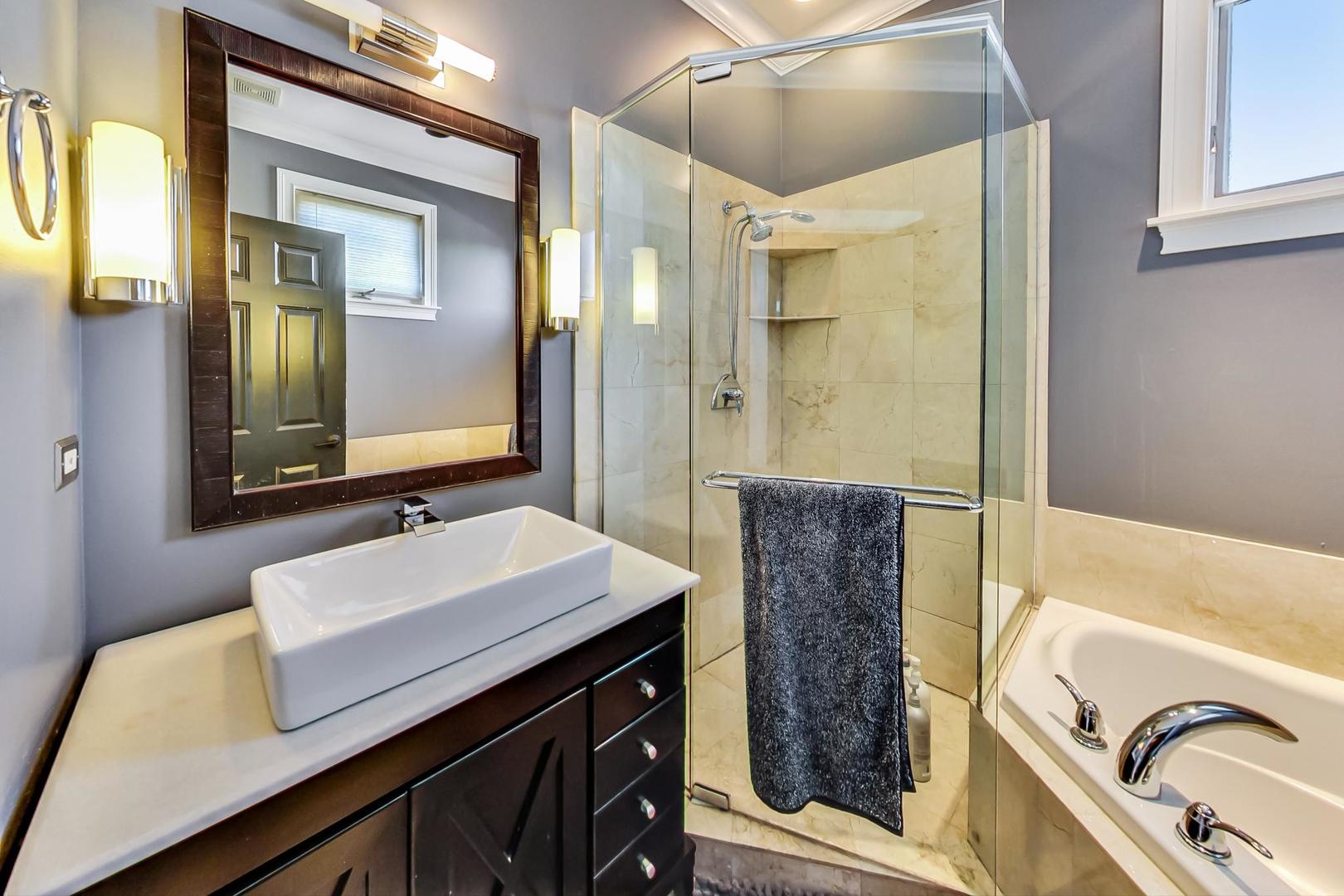 2128 West Walton Street, Unit 3W Chicago, IL 60622 - Photo 16 of 25 a bathroom with a tub sink and mirror