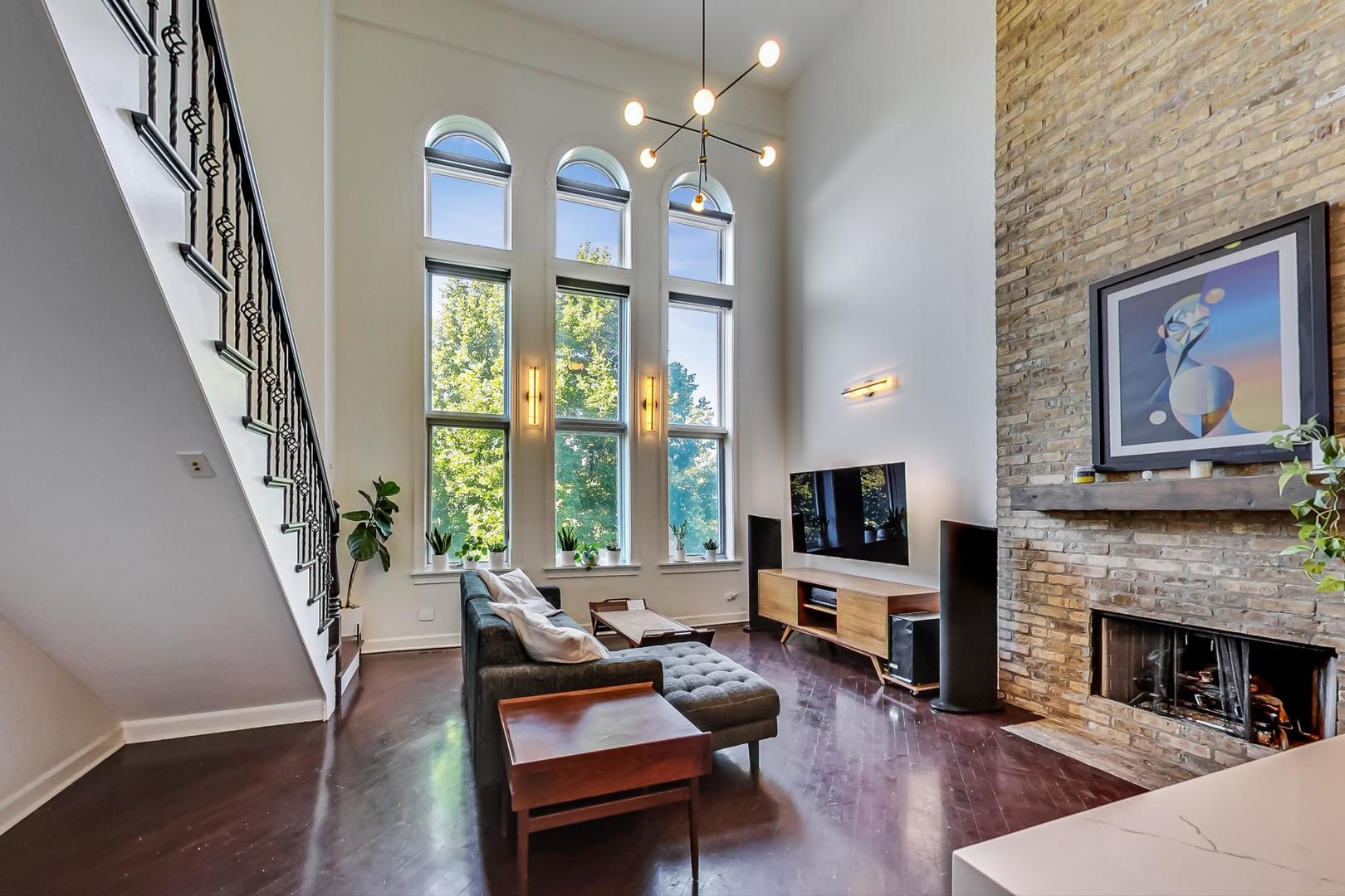 2128 West Walton Street, Unit 3W Chicago, IL 60622 - Photo 2 of 25 a living room with furniture a fireplace and a flat screen tv
