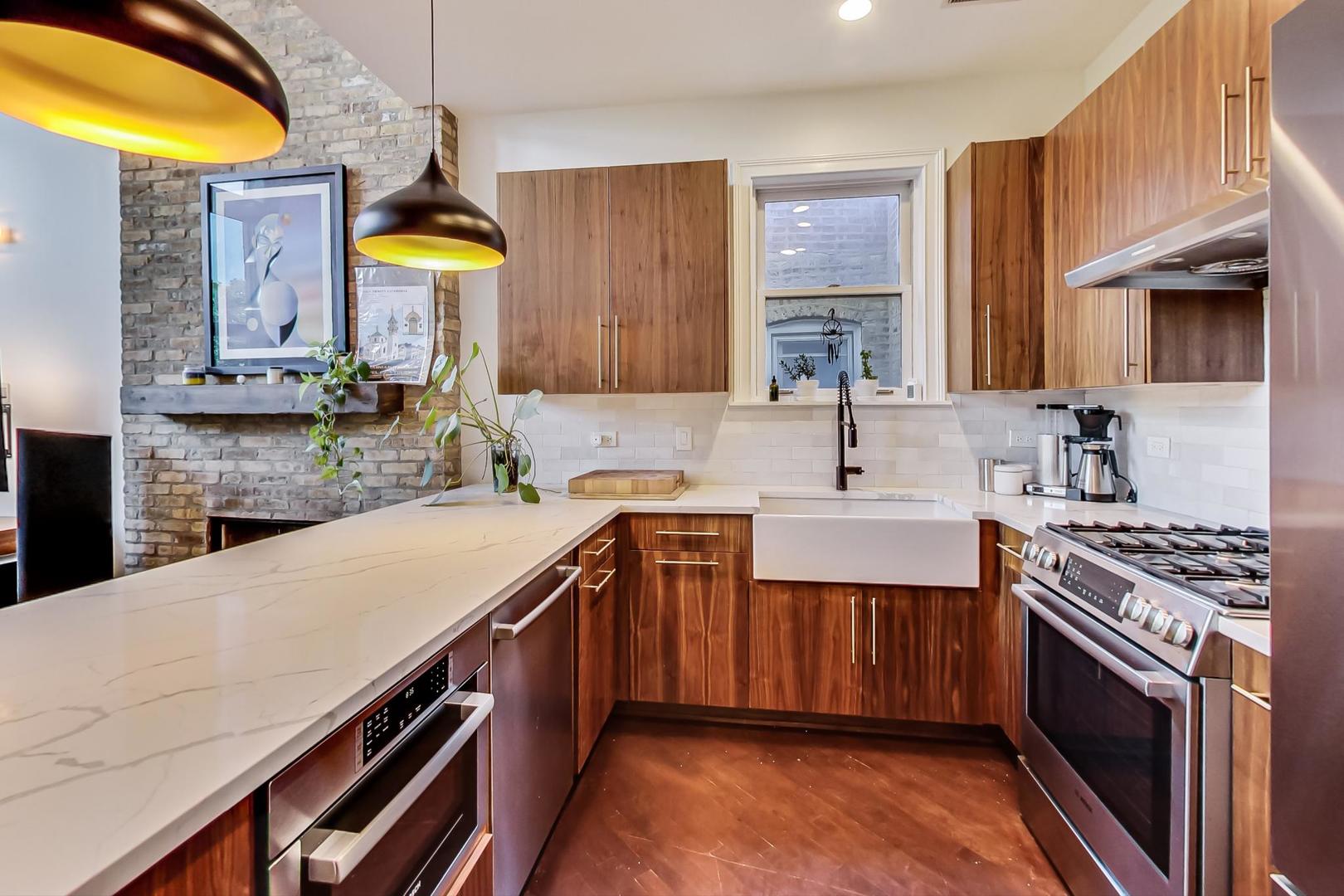 2128 West Walton Street, Unit 3W Chicago, IL 60622 - Photo 4 of 25 a kitchen with a sink a stove and cabinets