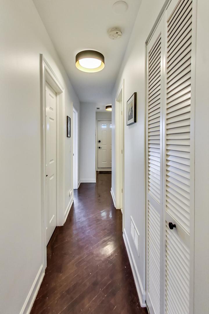 2128 West Walton Street, Unit 3W Chicago, IL 60622 - Photo 6 of 25 a view of a hallway with wooden floor and staircase