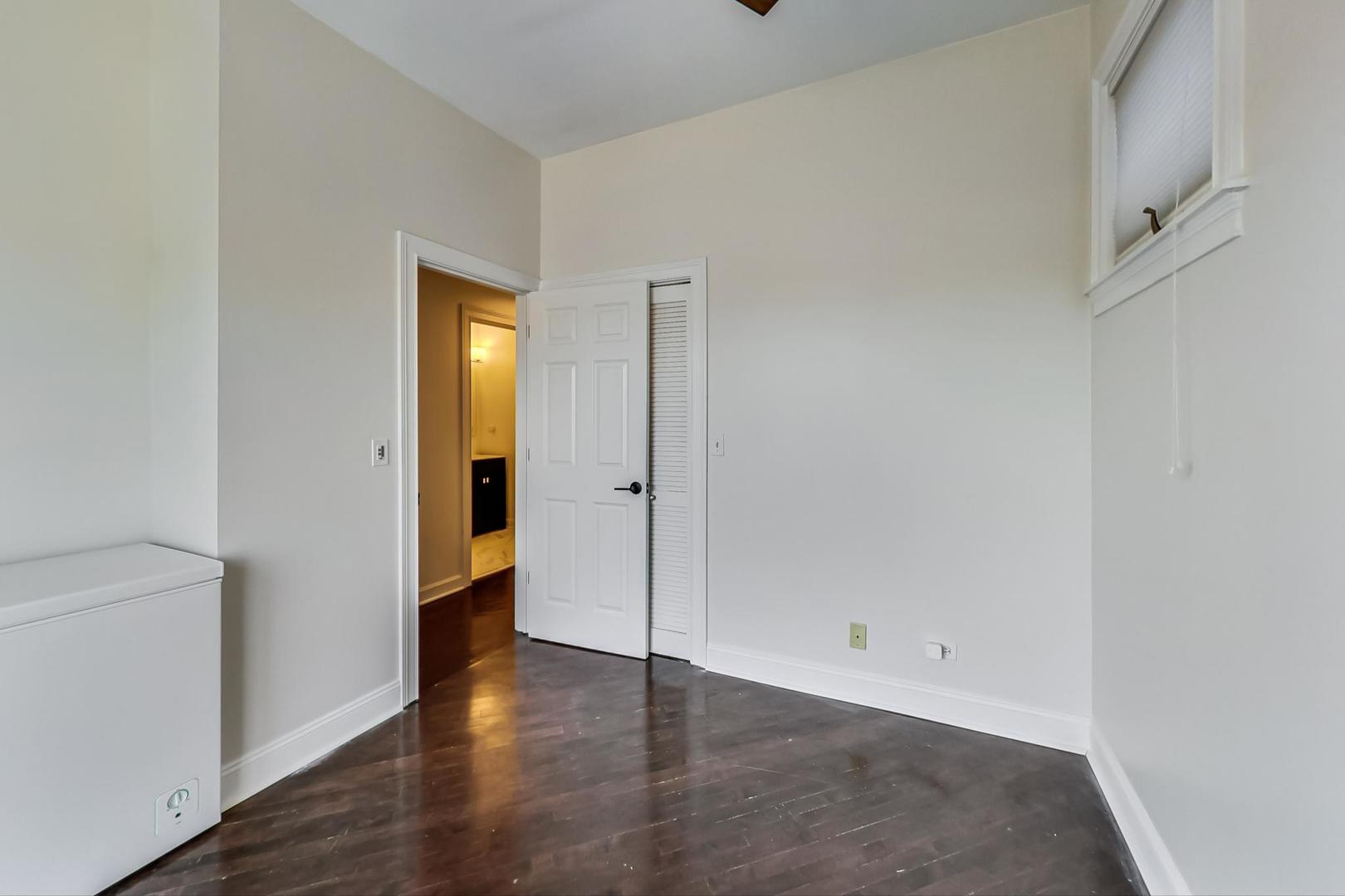 2128 West Walton Street, Unit 3W Chicago, IL 60622 - Photo 9 of 25 a view of an empty room with wooden floor and a window