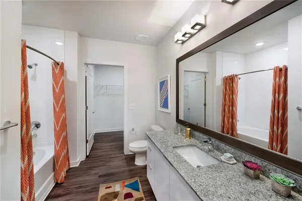 a kitchen with stainless steel appliances kitchen island granite countertop a table chairs sink and cabinets